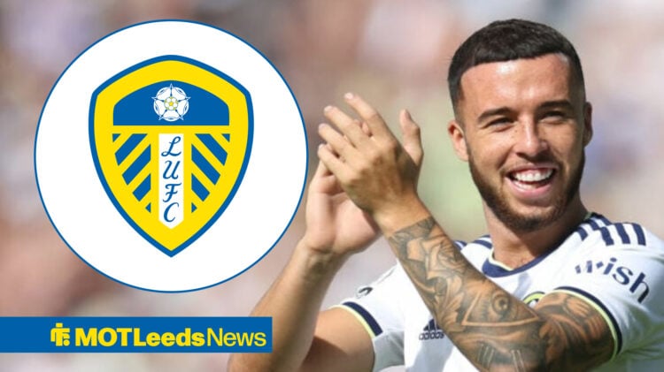 Sam Greenwood smiling and clapping in Leeds home shirt alongside Leeds crest