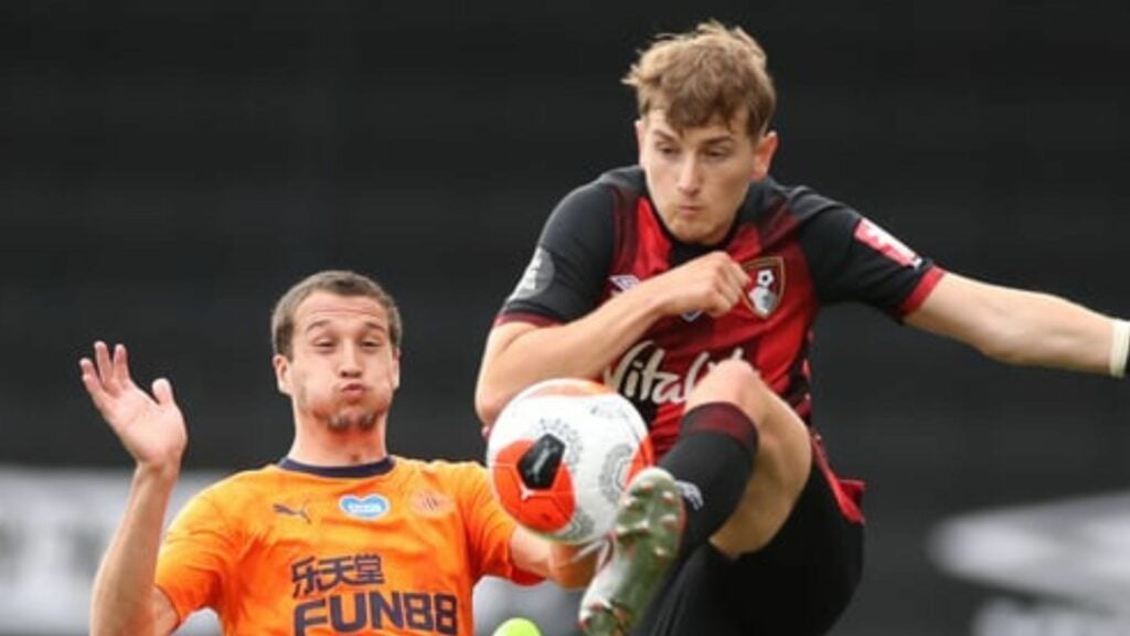 David Brooks in Bournemouth home shirt battles for the ball against Newcastle