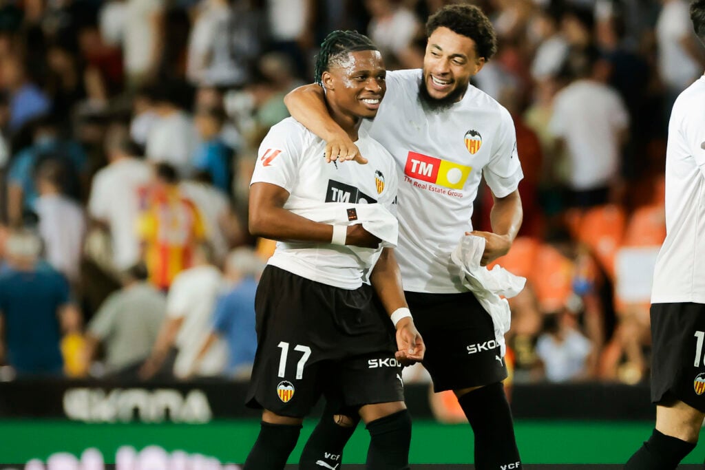 Leeds United loanee Largie Ramazani is hugged by one of his Valencia teammates.