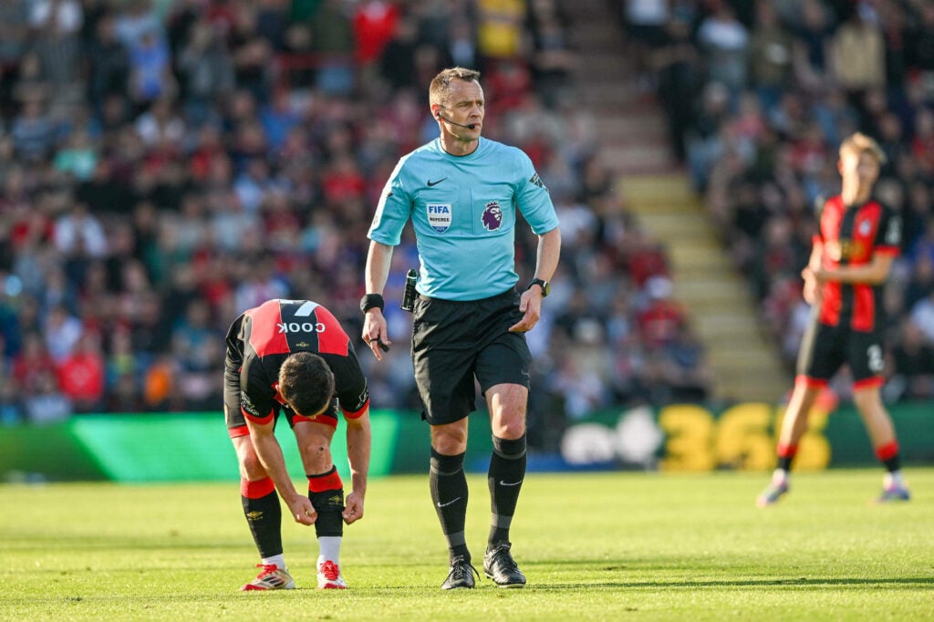 Stuart Attwell refereeing standing next to a Bournemouth player