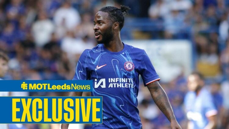 Raheem Sterling looking to the left in Chelsea home shirt