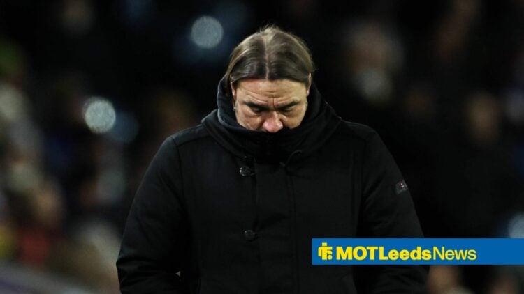 Daniel Farke looks downcast in a large black coat