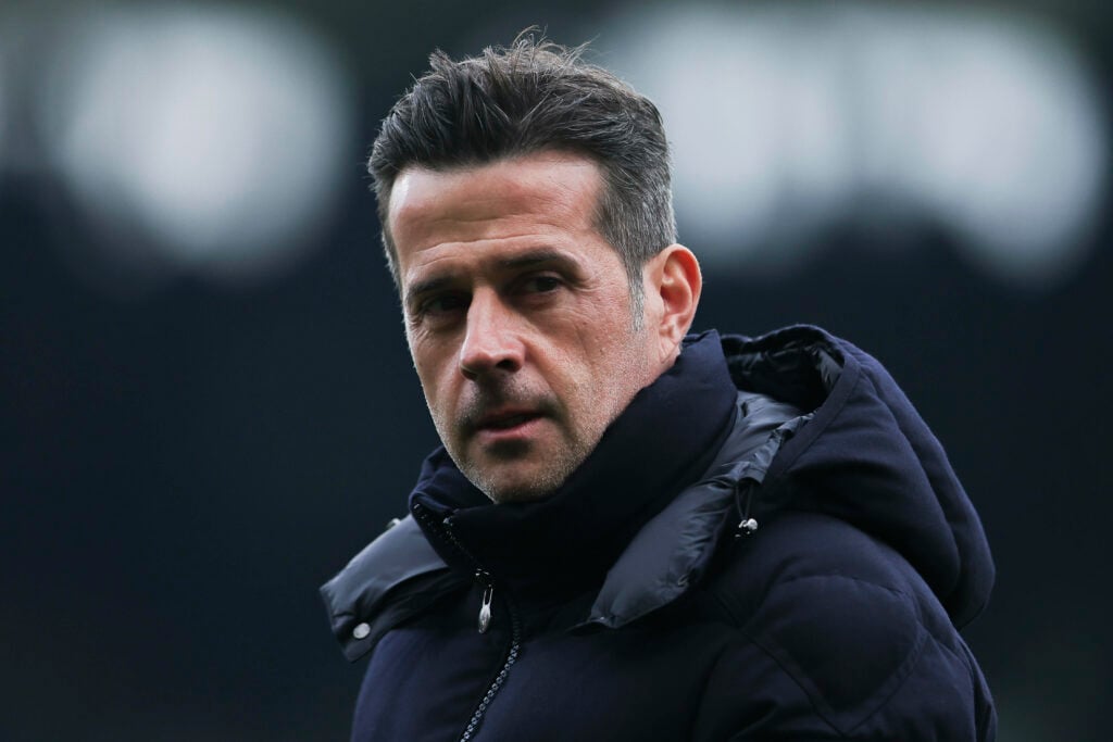 Fulham manager Marco Silva stares concernedly to his left while standing on the touchline.