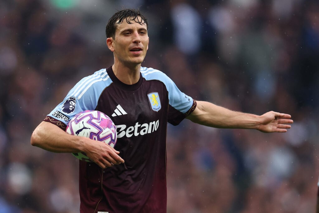 Pau Torres holding a ball and pointing for Aston Villa