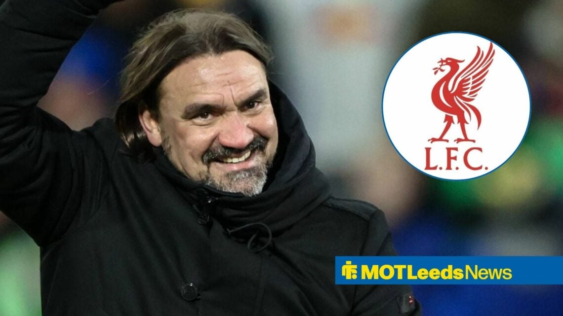 Daniel Farke smiling at Liverpool badge.