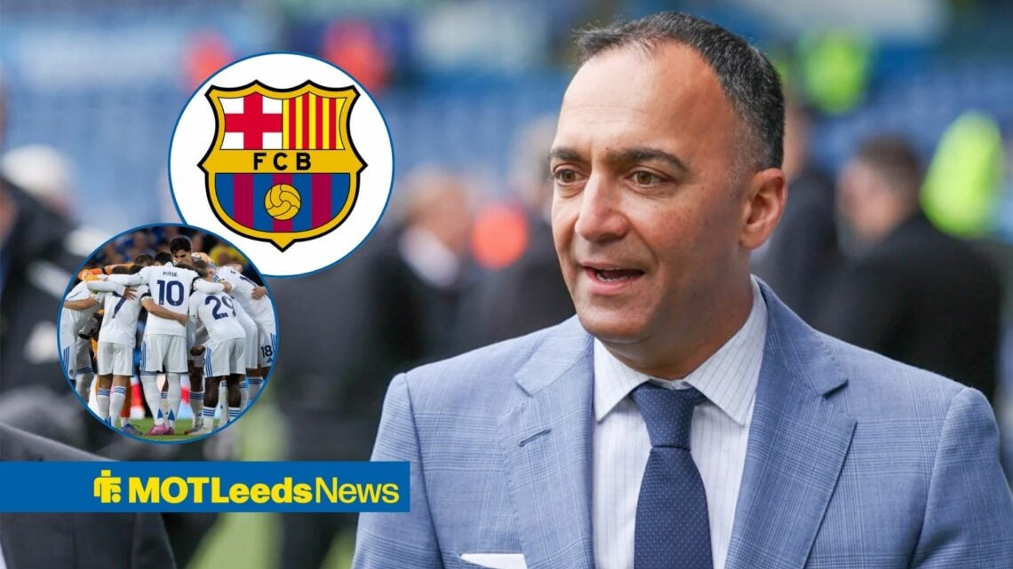 Paraag Marathe smiling in the direction of Leeds United squad and FC Barcelona badge.