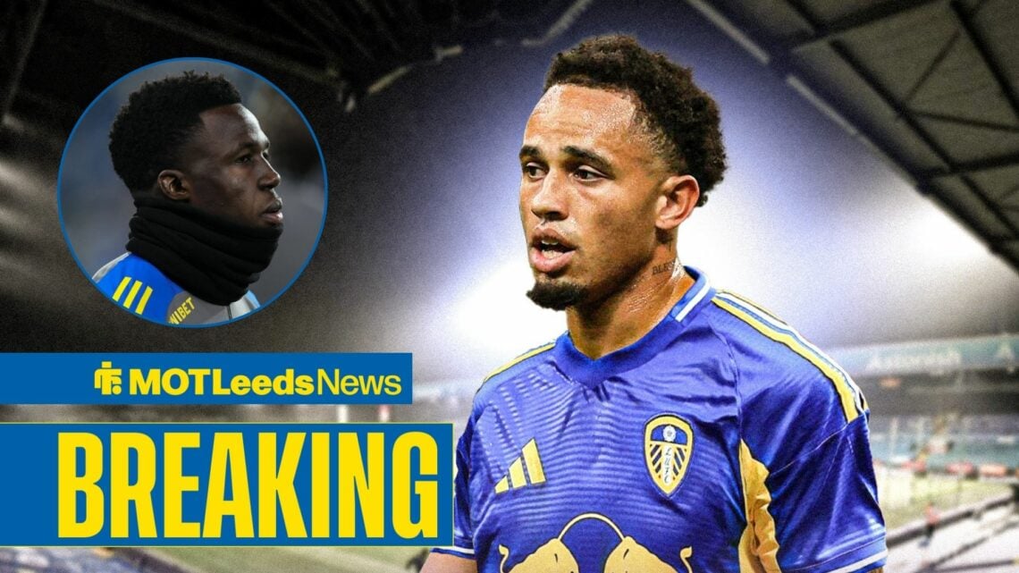 Leeds United star Noah Okafor looking at team-mate Wilfried Gnonto, who is warming up while wearing a snood.