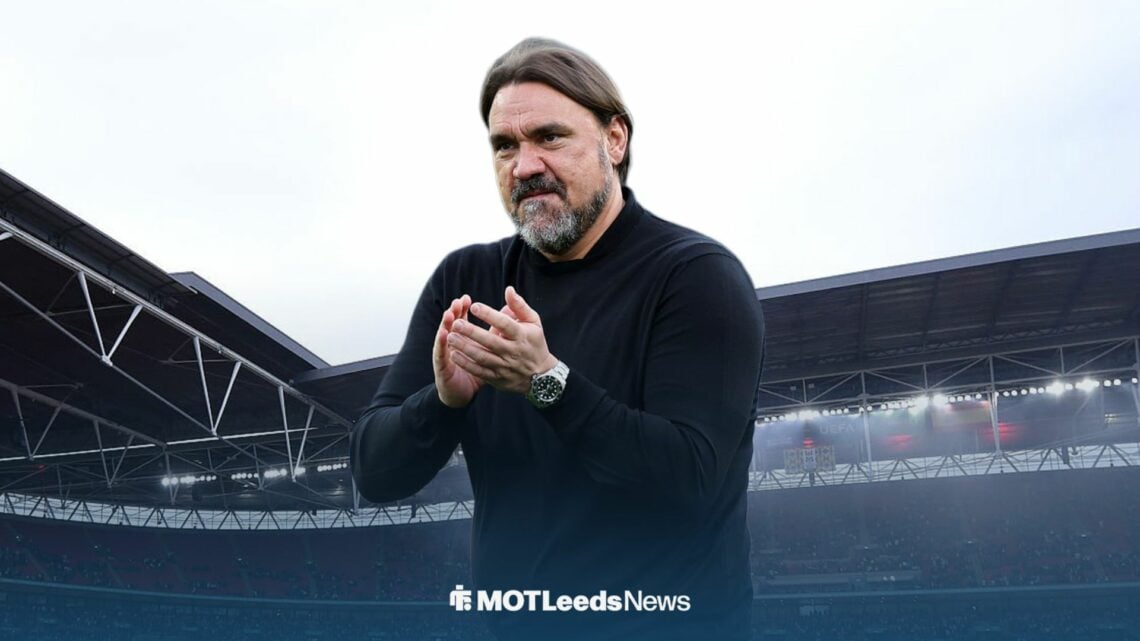 Leeds United boss Daniel Farke clapping with Wembley Stadium in the background.