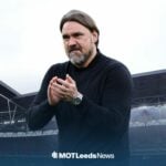 Leeds United boss Daniel Farke clapping with Wembley Stadium in the background.