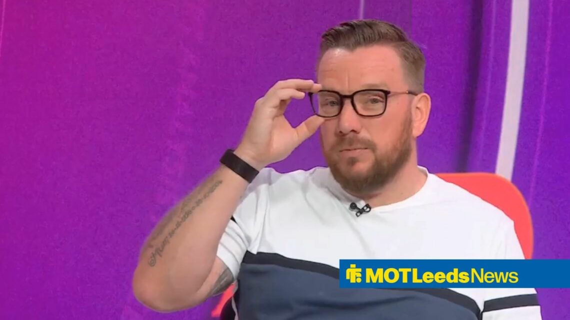Jamie O'Hara touches his glasses while working as a pundit